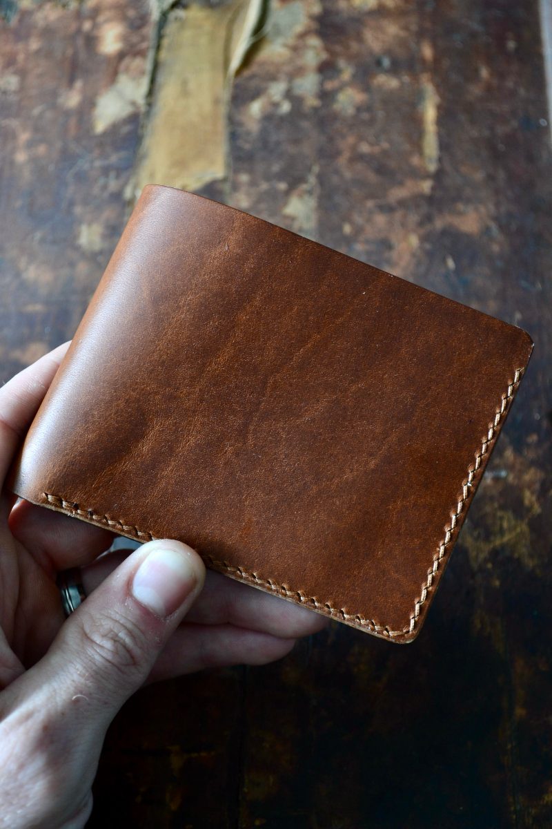 Brown classic bifold wallet in hand